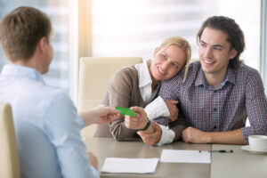 Real estate agent giving business card to client