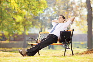 real estate agent sitting on a bench smiling