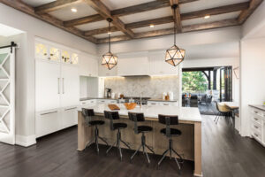 Kitchen Interior with Island, Sink, Cabinets, and Hardwood Floors in New Luxury Home