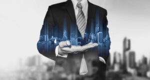 a holograph of skyscrapers in a man's hand illustrating how listings can turn into social media leads