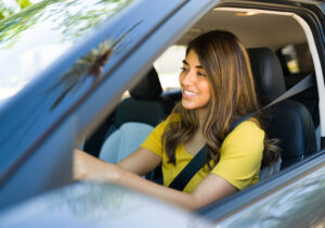 woman driving in car listening to podcast
