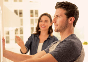 smiling couple looking at their home decorations
