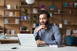 Smiling man in front of computer