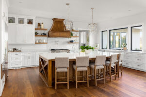 White kitchen with wooden chairs and accents