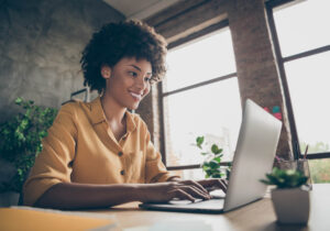 woman writing on a laptop