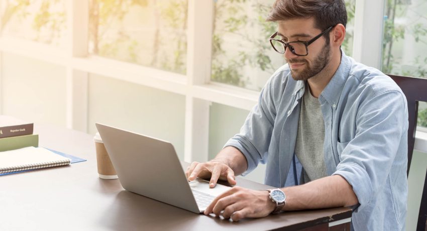 Man with glasses sitting in front of computer