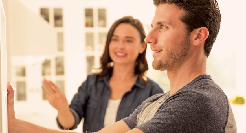 smiling couple looking at their home decorations