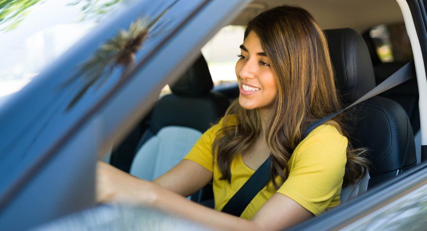 woman driving in car listening to podcast