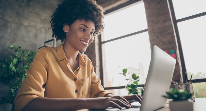 woman writing on a laptop