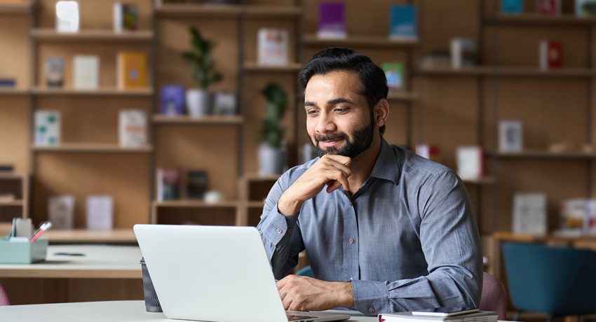 Smiling man in front of computer