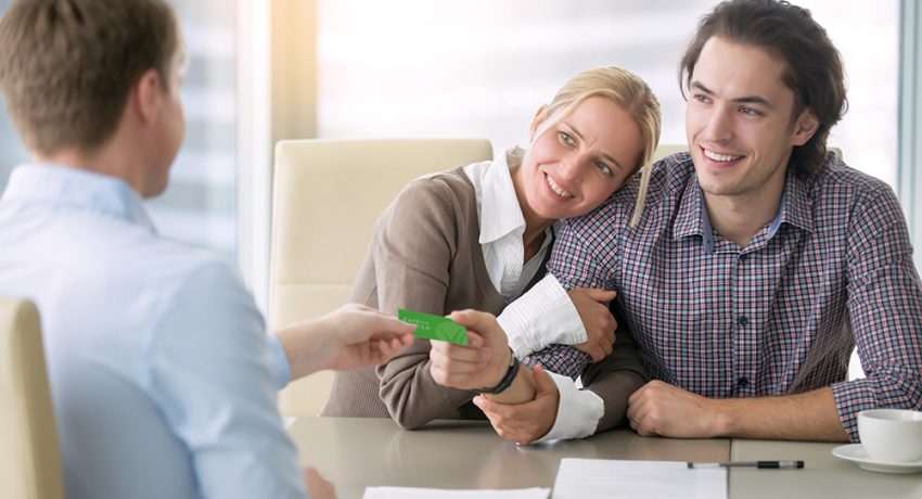 Real estate agent giving business card to client