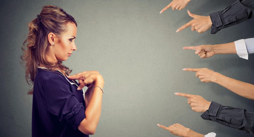 Blaming you. Anxious angry woman judged by different people pointing fingers hands at her. Negative human emotions face expression feeling