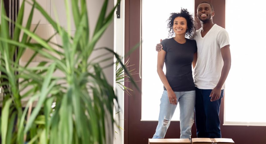 millennial couple walking into new home