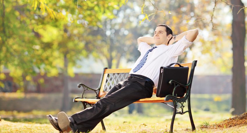 real estate agent sitting on a bench smiling