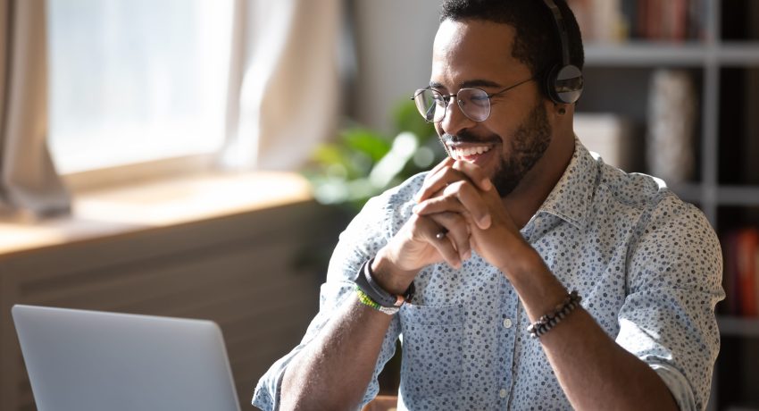 Smiling young mixed race businessman holding video call with clients partners.