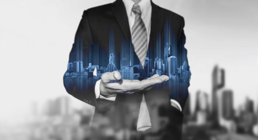 a holograph of skyscrapers in a man's hand illustrating how listings can turn into social media leads